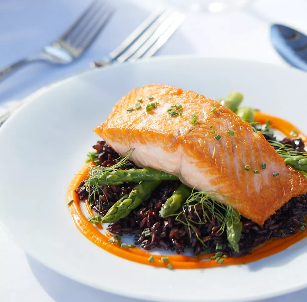 Roasted salmon on the asparagus bed and glass of white wine